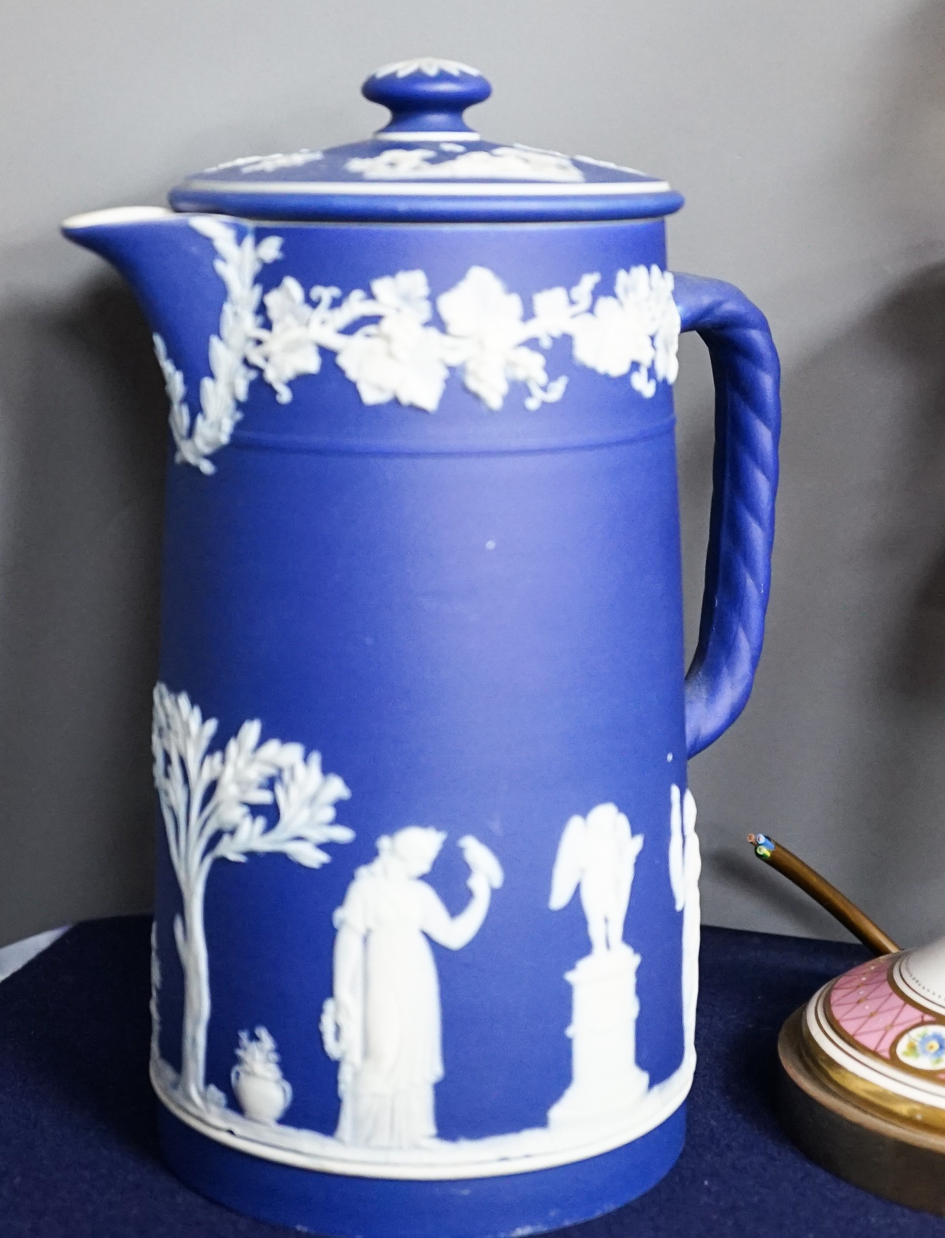 Three mid to late 19th century pieces of Wedgwood Jasperware, including a coffee pot and a small cashe-pot, a pair of 19th century porcelain candlesticks converted into lamps